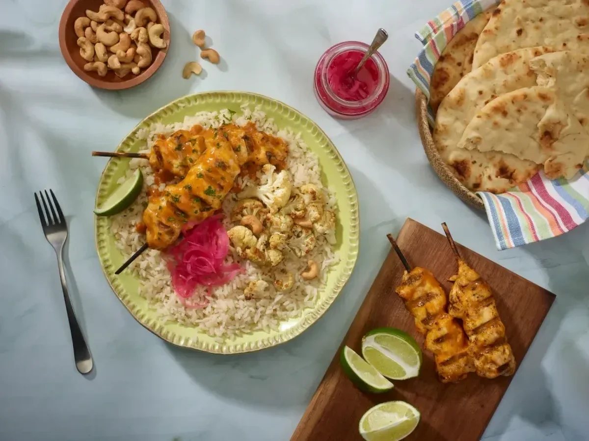 Butter Chicken Bowl with SunRice Protein+ Jasmine Rice and chicken skewers